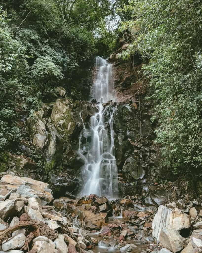 Cascada San Ramon waterfall dropping down rocky ledges surrounded by lush greenery in Boquete