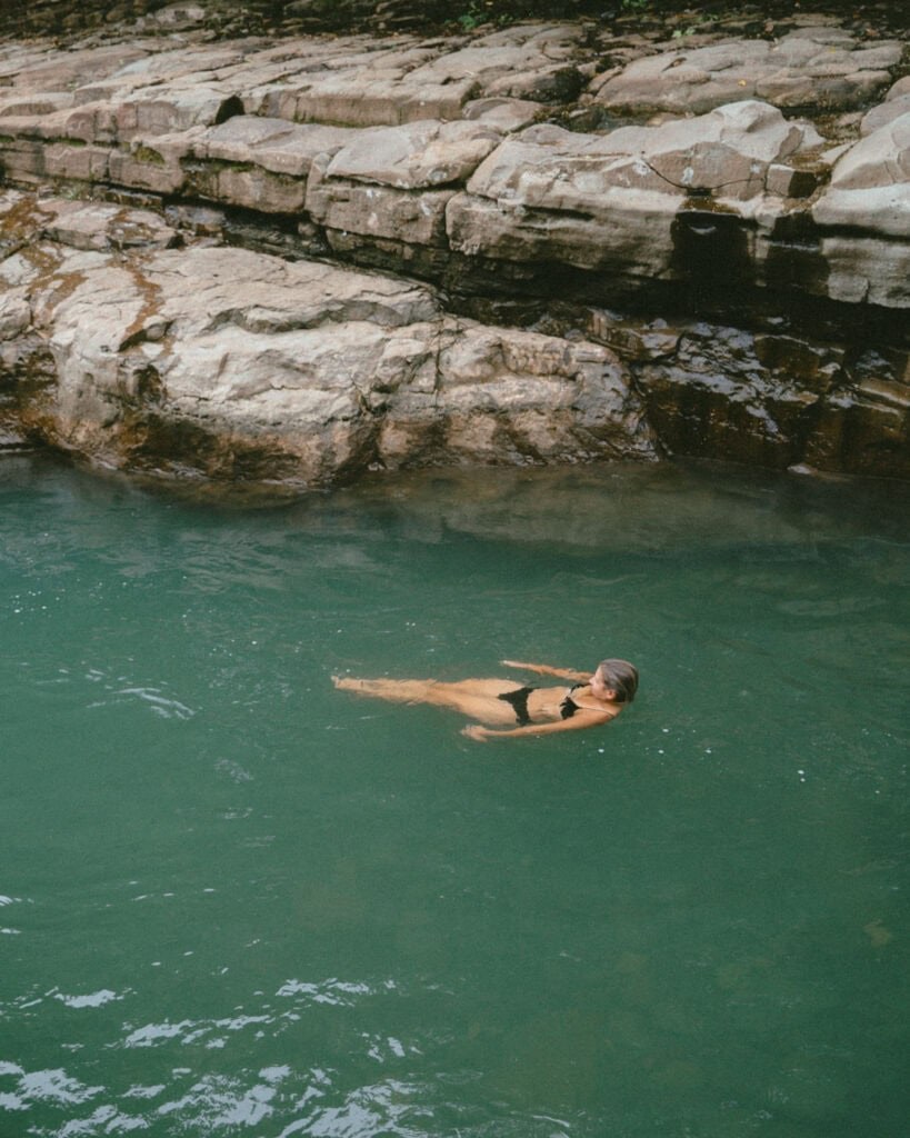 Swimmer enjoying the crystal clear water pool of a waterfall canyon in Chiriqui