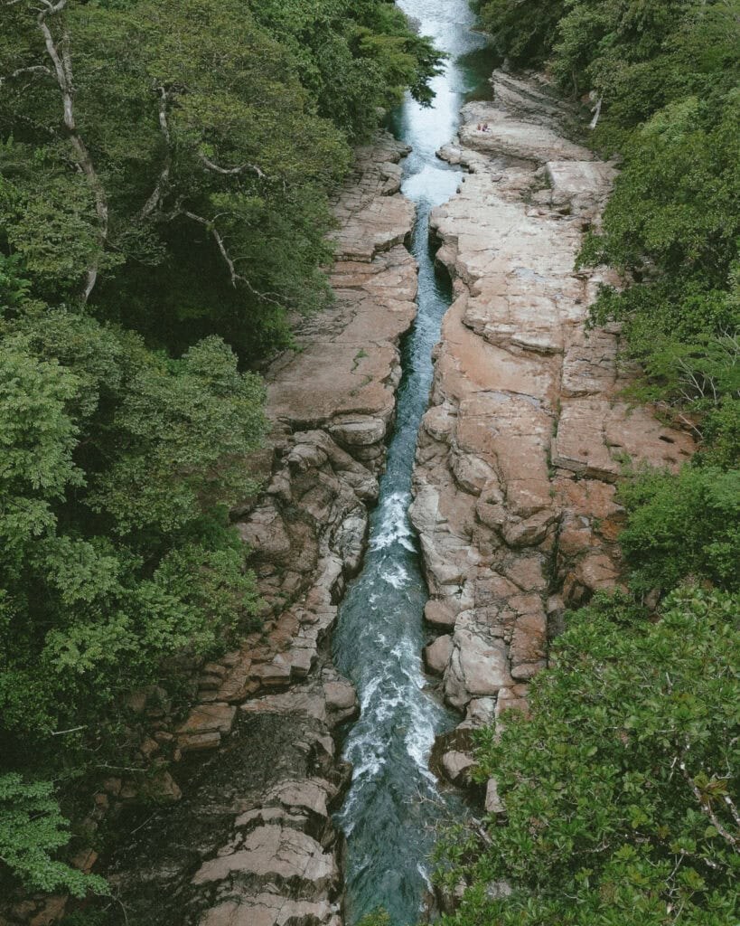 Aerial view of rushing river waters navigating the narrow rock formations at Los Cangilones de Gualaca