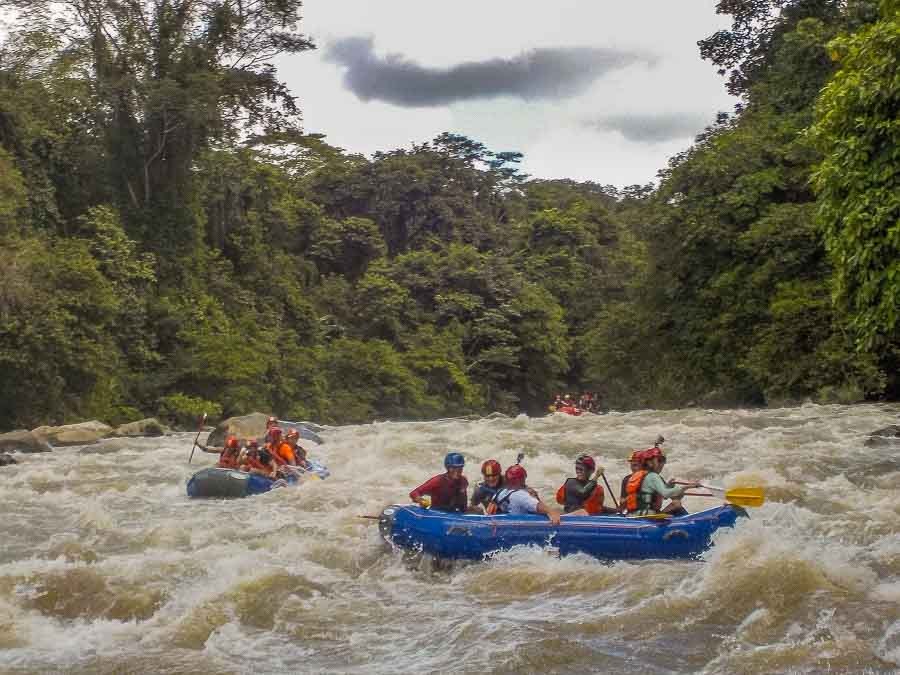 Raft plunging through turbulent white water rapids on the Chiriqui river in Panama