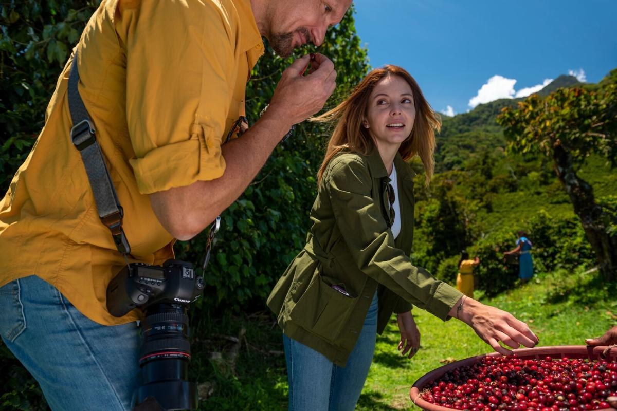 Romantic couple walking hand-in-hand through lush highland coffee gardens in Boquete