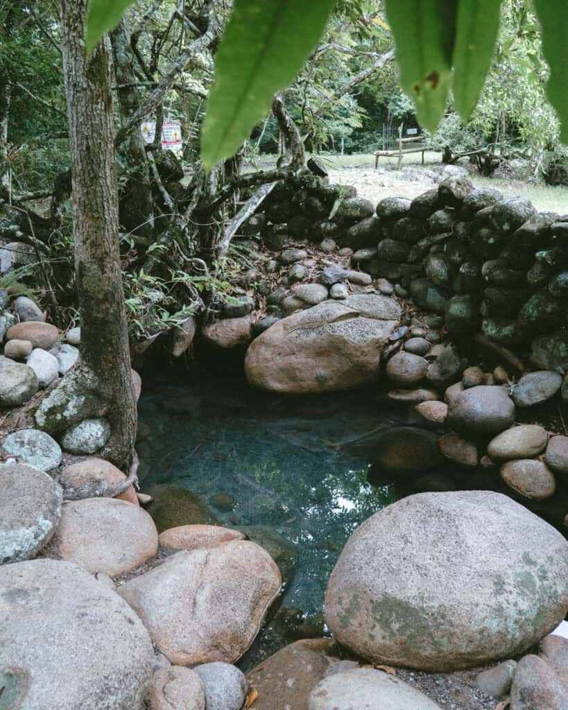 Natural rock thermal pool surrounded by tropical vegetation in Caldera near Boquete